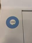 Blue round LOAD button with a green indicator light on the white reader housing