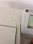 Tilted close-up of the spectrophotometer top covers and display with a finger on the keypad