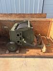 Two-wheel military green hose reel cart in an open crate, hose on the spool, side view