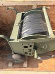 Hose reel cart from the side, showing the slotted side plate, reel flange, hose coupling and wheel