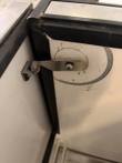 Stainless latch arm and hinge catch at the inside corner of the cooler lid frame