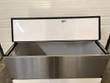 Milk cooler top lid raised with key lock above the open stainless drop-front door and empty interior