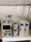 Full Jasco HPLC set on a white table: stacked detector and sampler, two pumps and two column ovens