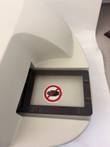 Plate tray opening on the BioTek FL600 reader with a black plate carrier frame and no-hands warning label
