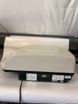 Side of the BioTek FL600 reader with power cord and rear label panel on the black base