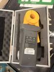 Back of the Extech ground resistance clamp meter in its foam-lined case with the battery label