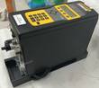 Stanley CELL-04 controller with yellow keypad and display, seen from the side with its mounting base