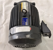 Mitsubishi three-phase motor standing on end, fan cover with vent grille at the bottom and terminal box at right