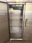 Atosa reach-in refrigerator with the left door open, three white wire shelves and evaporator fan inside