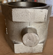 Side of a butterfly valve body with a cast boss and the threaded end