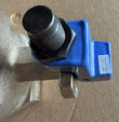 Blue handle cover, black threaded stem nut and inspection label on a butterfly valve body