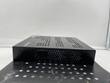 Opposite side of the black Enterasys switch, hex vent holes and the logo at the top front corner