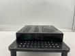 Side of a black Enterasys switch with perforated steel case and hex vent holes, on a black riser