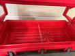 Red insulated cart well with a metal divider and center drain, end doors raised, gray casters and frame below