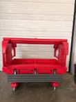 Red insulated carrier on casters with both end doors swung open, well and gray bumper rail visible