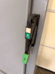 Black panel disconnect handle with green and red lockout tab, marked OFF (RESET)