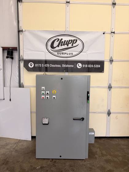 Gray SCE industrial control panel enclosure with pushbuttons, emergency stop and programming port, door closed