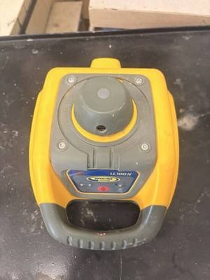 Yellow and gray Spectra Precision LL100N rotary laser level, top view of rotor dome and carry handle
