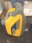 Yellow and gray Spectra Precision rotary laser level, side view with blue striped panel and gray carry handle
