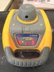 Yellow and gray Spectra Precision LL100N rotary laser level, front view with control panel and carry handle
