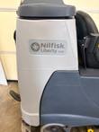 Nilfisk Liberty SC60 badge on the gray tank side panel, light scuffs on the plastic