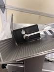 Black product holder pad and swing arm over the ribbed carriage tray of the Bizerba slicer