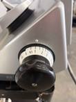 Slice thickness dial and black knob on the Bizerba slicer, scale marked 0 to 24 mm