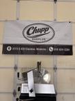 Bizerba GSP HD 33 slicer with carriage and product holder raised, below a Chupp Surplus banner
