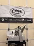 Bizerba SE 12 D slicer on a black cart with carriage tilted up, Univex service sticker on the housing