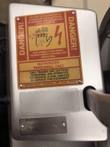 Red and yellow Bizerba USA danger label above the Bizerba SE 12 D US serial plate on the slicer housing