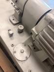 Pump bracket, breather cap and fitting on the gray reservoir top