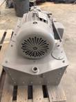 Hydraulic power unit seen from the motor end: Delco motor with fan cover on a bolted steel tank, on a pallet