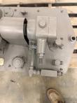 Top of the hydraulic reservoir with pump, JIC fittings, check valve and breather cap