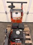 Top view of walk-behind floor saw: handlebar, handwheel, white water tank, Cyclone air cleaner and gas engine