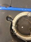 Rotary peeler ring in case foam with black rubber handle, roller bolt and hinge; ring cropped by frame
