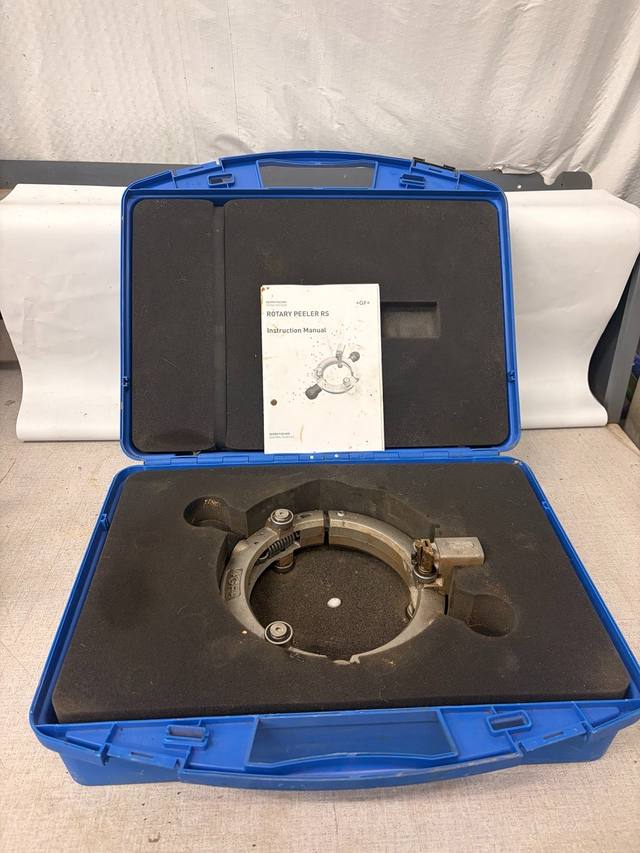 Open blue GF carrying case holding the silver Rotary Peeler RS ring in foam, instruction manual on the lid